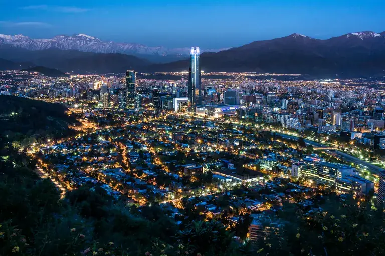 Santiago at blue hour, city lights below the snow-capped Andes
